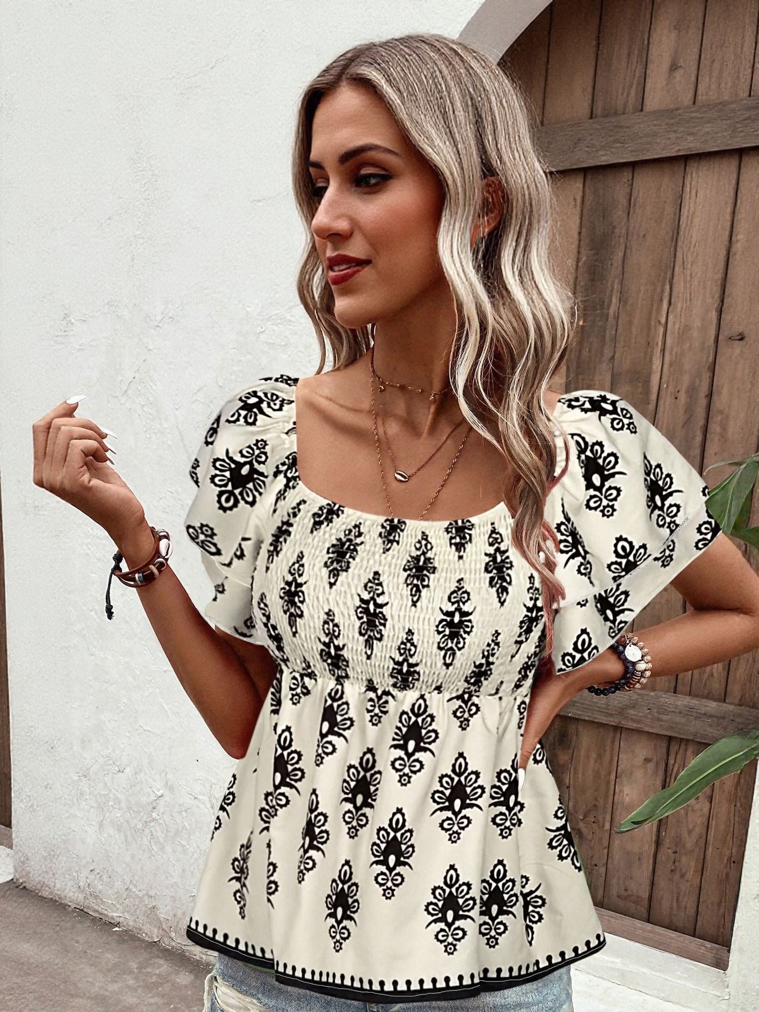 Off White Top With Flared Sleeve And Smocking Detail